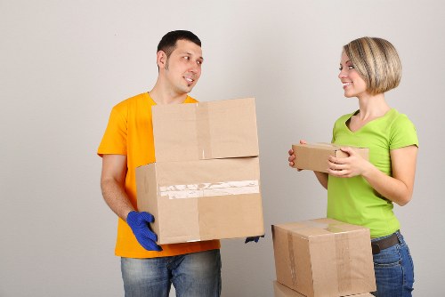 Employee handling stored goods using safe lifting practices